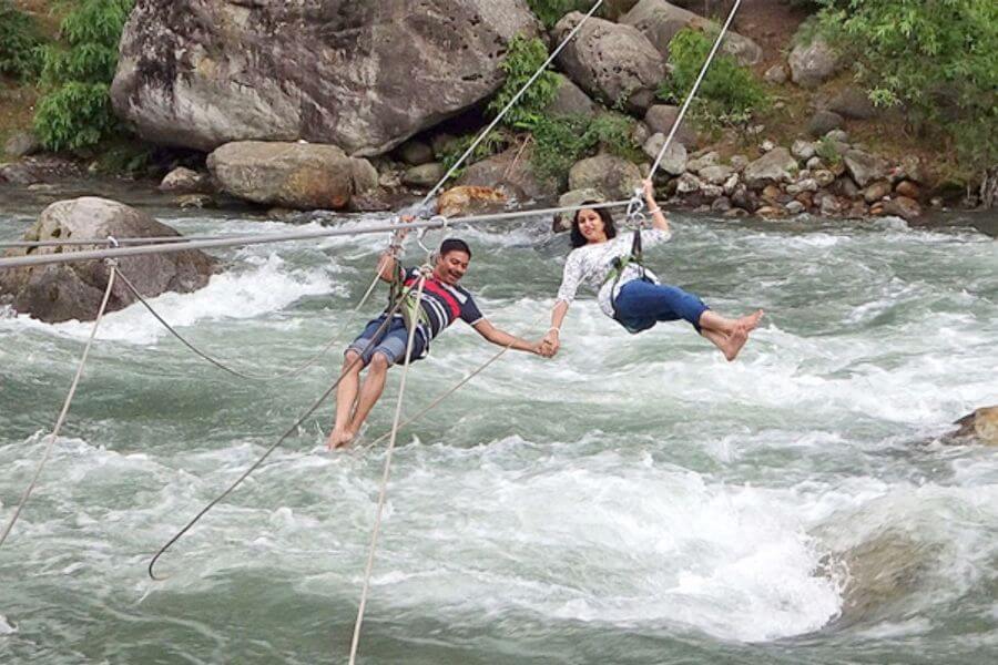 Adventure seekers enjoy thrilling activities in the breathtaking landscape of Manali.