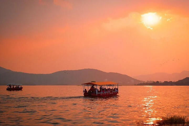 Enjoy a sunset boat ride on Lake Pichola